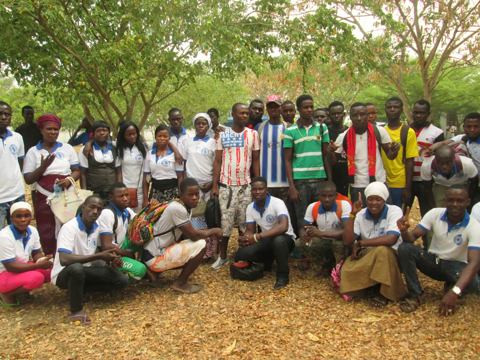 Students of the Peace Adults School of City of God, gathered under the trees